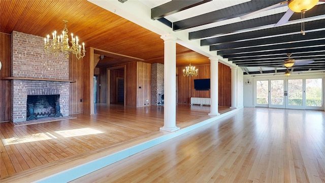 150 Senix Ave, Center Moriches, NY 11934 - unfurnished living room with a chandelier, a fireplace, ornate columns, hardwood / wood-style floors, and beamed ceiling