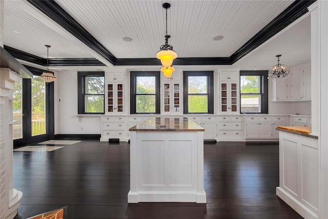 150 Senix Ave, Center Moriches, NY 11934 - kitchen featuring dark wood-style flooring, white cabinetry, a chandelier, ornamental molding, and decorative light fixtures