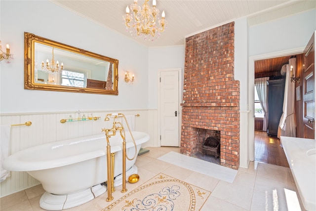 150 Senix Ave, Center Moriches, NY 11934 - full bathroom featuring a chandelier, a freestanding tub, ornamental molding, wainscoting, and tile patterned floors