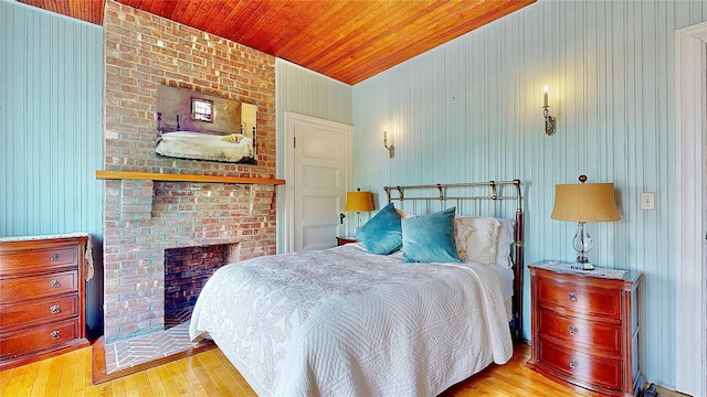 150 Senix Ave, Center Moriches, NY 11934 - bedroom featuring hardwood / wood-style floors, wooden ceiling, and a fireplace