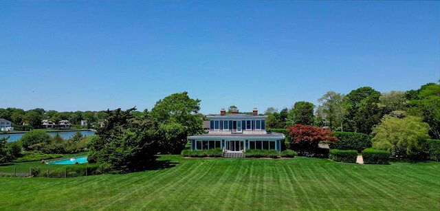 150 Senix Ave, Center Moriches, NY 11934 - back of property featuring a yard, a water view, and a chimney