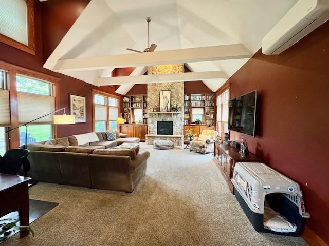 73 Gregory Way, Calverton, NY 11933 - carpeted living area with ceiling fan, an AC wall unit, a fireplace, and built in features