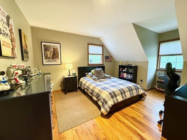73 Gregory Way, Calverton, NY 11933 - bedroom with light wood-type flooring and lofted ceiling