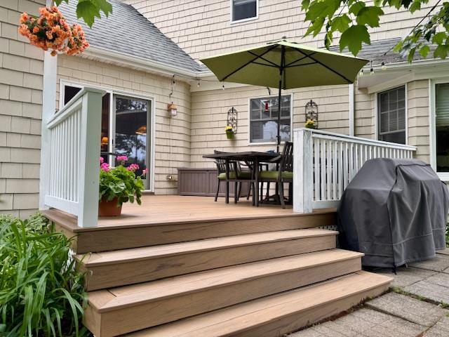 73 Gregory Way, Calverton, NY 11933 - wooden terrace with outdoor dining area and grilling area