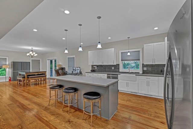 11 Fieldstone Ct, Highland, NY 12528 - kitchen featuring appliances with stainless steel finishes, backsplash, a sink, a chandelier, and white cabinets