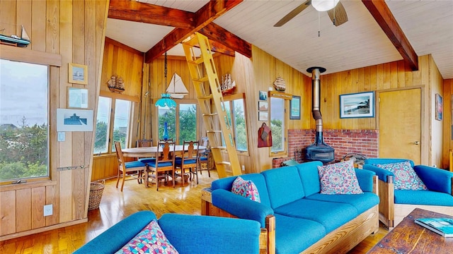 15 Dune Walk, Davis Park, NY 11772 - living room with wooden walls, ceiling fan, a wood stove, and hardwood / wood-style flooring