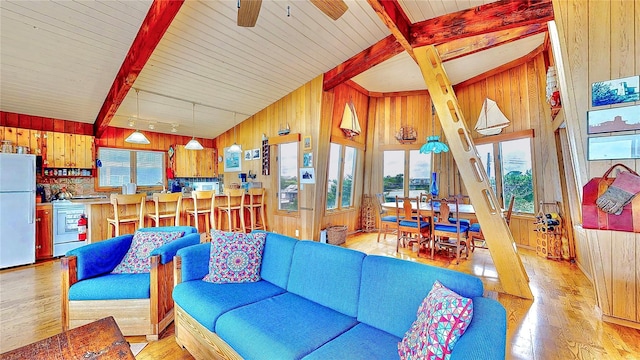 15 Dune Walk, Davis Park, NY 11772 - living area with wood walls, light wood-style flooring, beam ceiling, and a ceiling fan