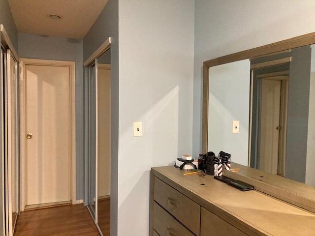 615 Broadway Unit 11, Amityville, NY 11701 - bathroom with wood finished floors, vanity, and baseboards