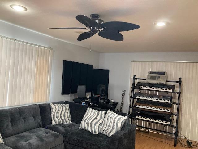 615 Broadway Unit 11, Amityville, NY 11701 - living area featuring wood finished floors, ceiling fan, and recessed lighting
