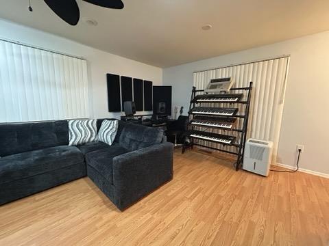 615 Broadway Unit 11, Amityville, NY 11701 - living area with light wood-style flooring, a ceiling fan, and baseboards