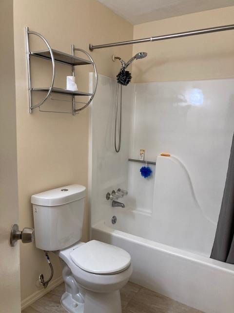 615 Broadway Unit 11, Amityville, NY 11701 - full bathroom featuring shower / bath combo with shower curtain, toilet, and baseboards