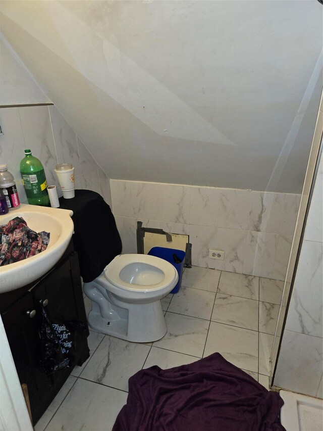 731 E 218th St, Bronx, NY 10467 - bathroom featuring marble finish floors, vanity, lofted ceiling, and tile walls