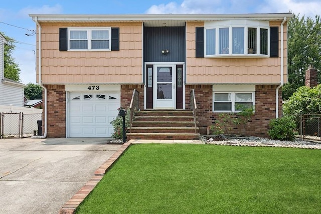 473 S 15th St, Lindenhurst, NY 11757 - split foyer home featuring brick siding, entry steps, driveway, and a garage