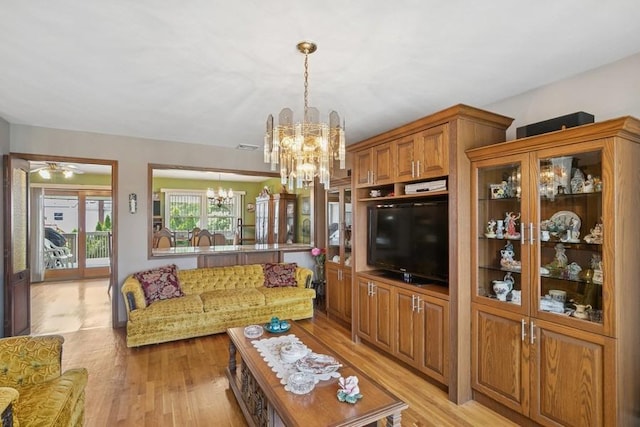473 S 15th St, Lindenhurst, NY 11757 - living area with a chandelier and light wood-style flooring