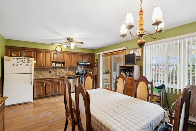 473 S 15th St, Lindenhurst, NY 11757 - dining area with a chandelier, light wood finished floors, and a ceiling fan