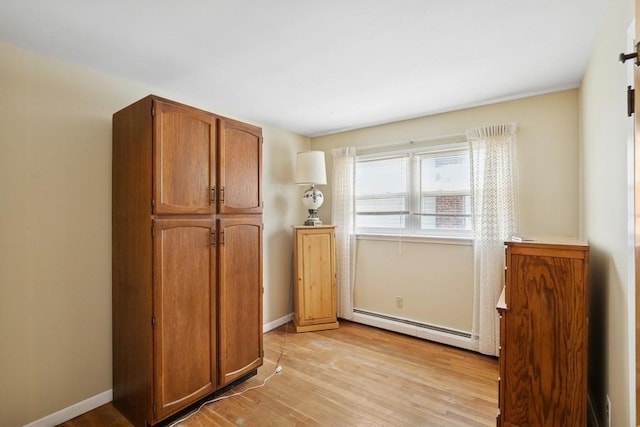 473 S 15th St, Lindenhurst, NY 11757 - doorway with baseboard heating and light wood-style floors