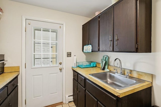 473 S 15th St, Lindenhurst, NY 11757 - kitchen featuring light countertops, baseboard heating, and dark brown cabinets