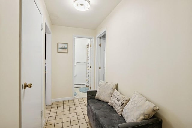 473 S 15th St, Lindenhurst, NY 11757 - living room featuring a baseboard heating unit and light tile patterned floors