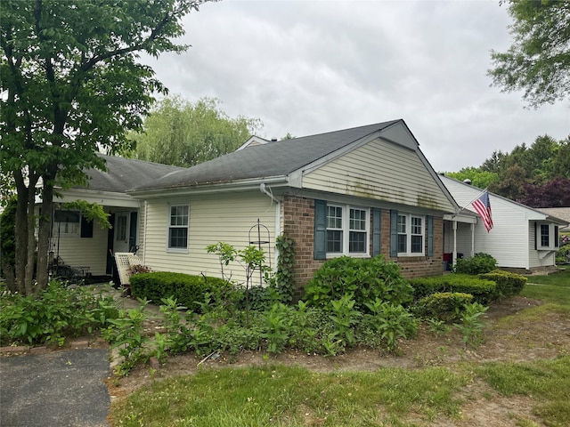 9 Forge Ln, Coram, NY 11727 - view of side of home with brick siding
