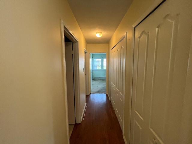 9 Forge Ln, Coram, NY 11727 - hallway with dark wood-type flooring, a baseboard radiator, and baseboards