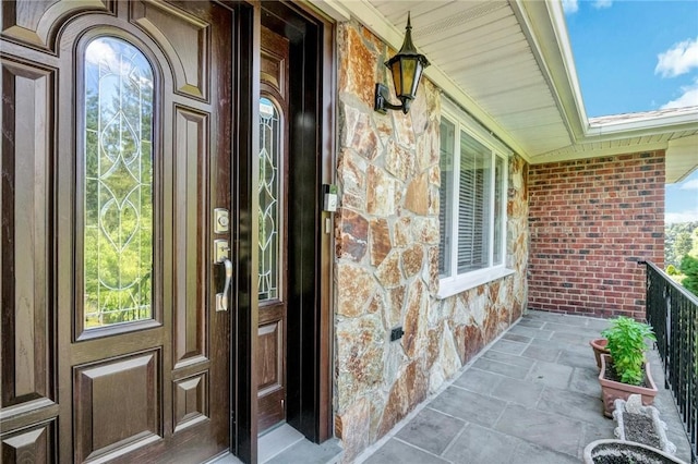 156 Valentine St, Yonkers, NY 10704 - view of exterior entry featuring covered porch and stone siding