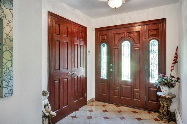 156 Valentine St, Yonkers, NY 10704 - entrance foyer featuring a baseboard heating unit, healthy amount of natural light, and baseboards