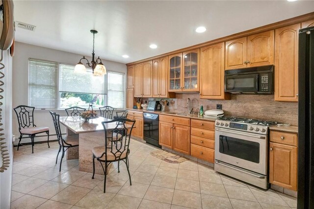 156 Valentine St, Yonkers, NY 10704 - kitchen featuring black appliances, a sink, a chandelier, light tile patterned floors, and backsplash