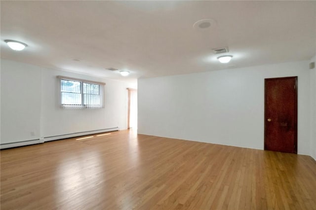 156 Valentine St, Yonkers, NY 10704 - unfurnished room with wood finished floors and a baseboard heating unit