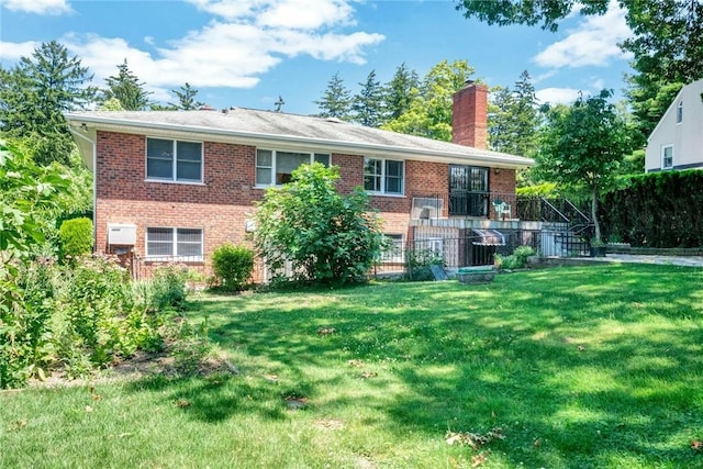 156 Valentine St, Yonkers, NY 10704 - view of front of home featuring a chimney, brick siding, and a front yard