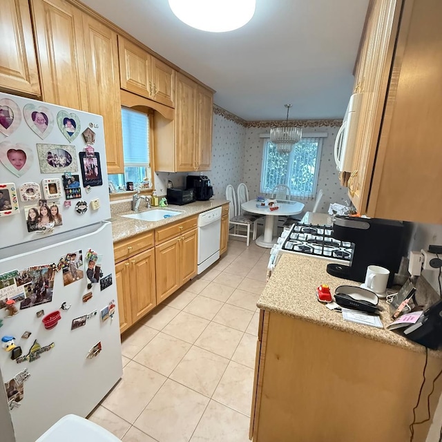 149-45 83rd St, Howard Beach, NY 11414 - kitchen featuring white appliances, a sink, wallpapered walls, light tile patterned floors, and plenty of natural light