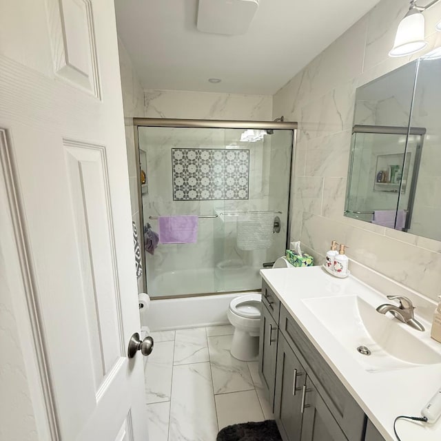149-45 83rd St, Howard Beach, NY 11414 - full bath featuring vanity, marble finish floors, toilet, and combined bath / shower with glass door
