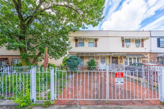 124 Herzl St, Brooklyn, NY 11212 - view of front of home with a fenced front yard, brick siding, and a gate