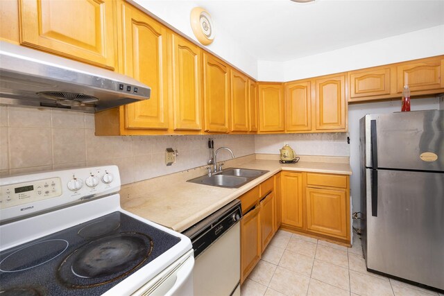 124 Herzl St, Brooklyn, NY 11212 - kitchen featuring white appliances, under cabinet range hood, a sink, light countertops, and light tile patterned floors