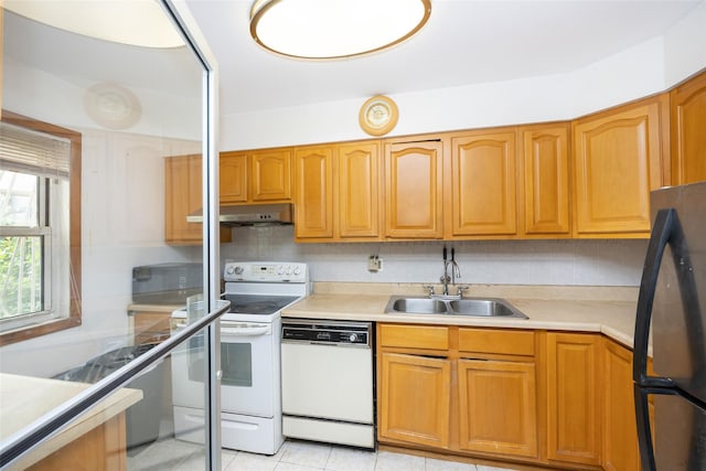 124 Herzl St, Brooklyn, NY 11212 - kitchen with white appliances, a sink, under cabinet range hood, light tile patterned flooring, and light countertops