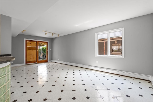 162-25 89th St, Howard Beach, NY 11414 - unfurnished room featuring a baseboard radiator, rail lighting, and tile patterned floors