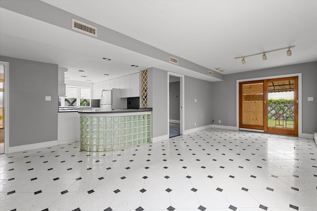 162-25 89th St, Howard Beach, NY 11414 - kitchen featuring dark countertops, white cabinetry, freestanding refrigerator, open floor plan, and rail lighting