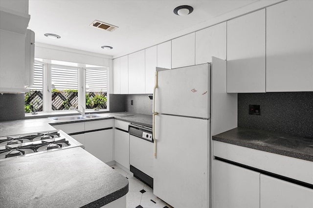 162-25 89th St, Howard Beach, NY 11414 - kitchen featuring white appliances, white cabinets, and backsplash