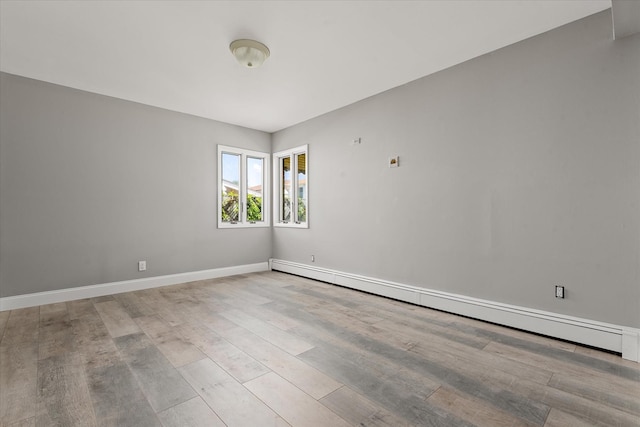 162-25 89th St, Howard Beach, NY 11414 - empty room with a baseboard heating unit and wood finished floors