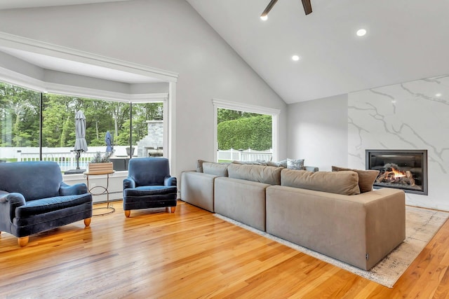 21 Buttonwood Dr, Dix Hills, NY 11746 - living area with wood finished floors, high vaulted ceiling, a fireplace, a ceiling fan, and recessed lighting