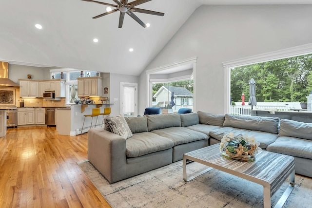 21 Buttonwood Dr, Dix Hills, NY 11746 - living room with a ceiling fan, high vaulted ceiling, light wood-style floors, and recessed lighting