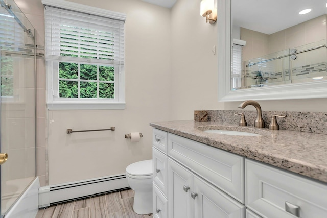 21 Buttonwood Dr, Dix Hills, NY 11746 - bathroom with a baseboard heating unit, vanity, toilet, enclosed tub / shower combo, and wood finished floors