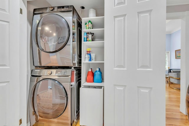 21 Buttonwood Dr, Dix Hills, NY 11746 - laundry room with estacked washer and dryer, wood finished floors, and crown molding