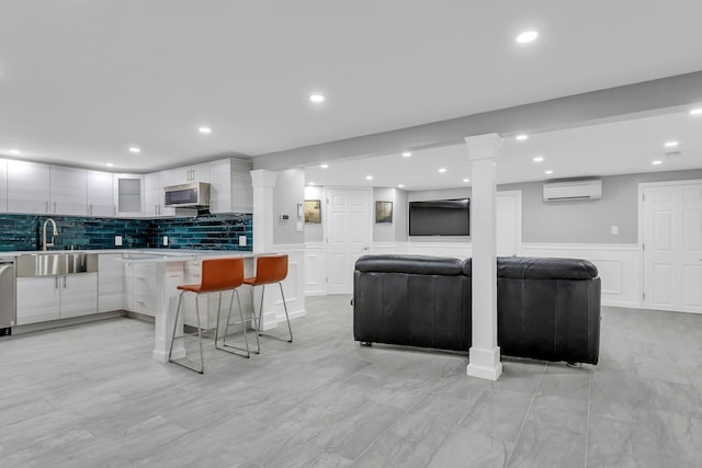 21 Buttonwood Dr, Dix Hills, NY 11746 - kitchen with a sink, a wall mounted air conditioner, modern cabinets, light countertops, and wainscoting