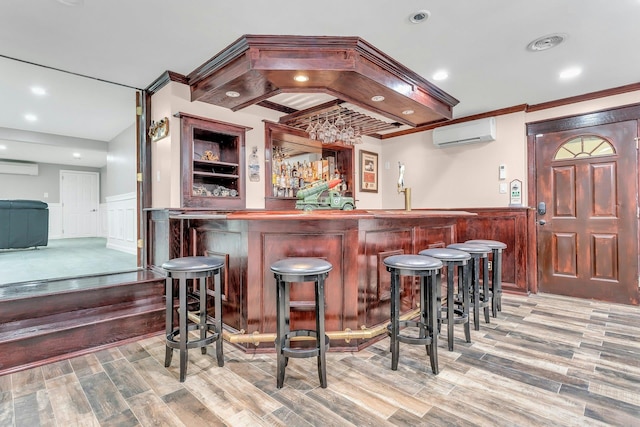 21 Buttonwood Dr, Dix Hills, NY 11746 - indoor wet bar featuring an AC wall unit, a wall mounted air conditioner, wainscoting, wood finished floors, and a decorative wall