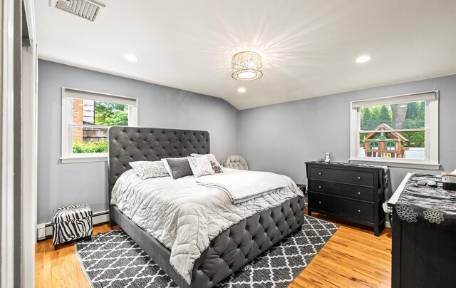 11 Gilford Ct, Melville, NY 11747 - bedroom with light wood-type flooring, recessed lighting, a baseboard heating unit, and a baseboard radiator