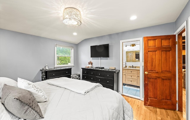 11 Gilford Ct, Melville, NY 11747 - bedroom with light wood-style floors, recessed lighting, ensuite bathroom, a sink, and vaulted ceiling