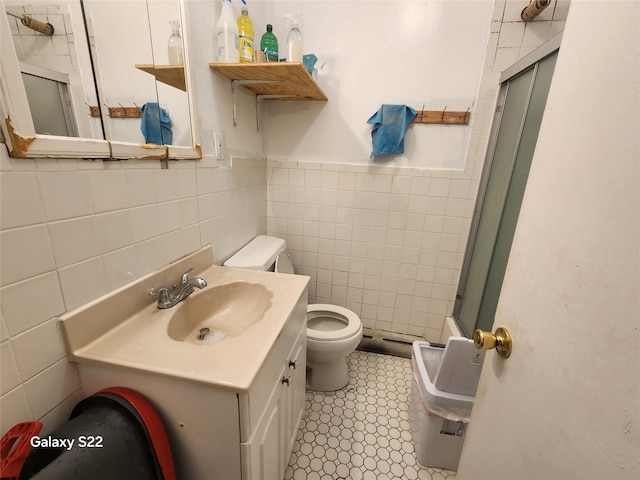 32 Yonkers Ave, Yonkers, NY 10701 - full bathroom with toilet, tile walls, an enclosed shower, vanity, and a wainscoted wall