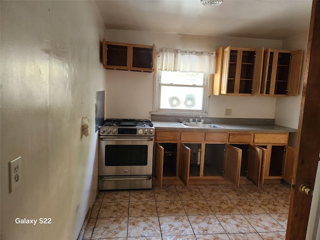 32 Yonkers Ave, Yonkers, NY 10701 - kitchen with stainless steel gas range, a sink, open shelves, and dark countertops