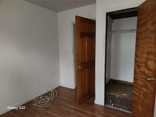 32 Yonkers Ave, Yonkers, NY 10701 - unfurnished bedroom with wood finished floors, a closet, and baseboards