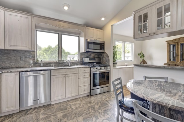 27 Suzanne Ln, Bethpage, NY 11714 - kitchen featuring stainless steel appliances, a sink, glass insert cabinets, decorative backsplash, and light stone counters